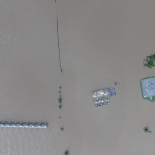 aerial photo of a flooded area with building roofs visible.