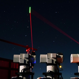 A photo of three lasers being transmitted from ground modules