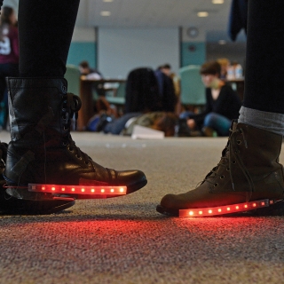 This course provides instructions for programming a wearable circuit board that measures resistance from a pressure-sensitive conductive sheet in the heel of the shoe. When resistance changes, red lights are triggered.
