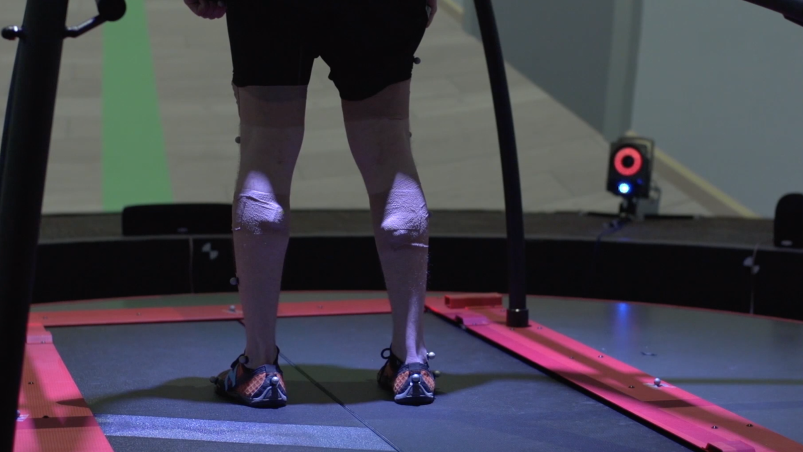 A participant walks on the treadmill in a virtual hospital hallway while the platform applies a rotation perturbation.