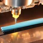 a photo of a 3d printer nozzle extriding material onto a piece of glass.