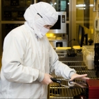 a technician loads a reticle (a kind of optical blueprint) into the 193-nm lithography tool used in the sensor production process.