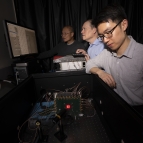 From left to right, Niyom Lue, Jonathan Richardson, and Tom Cheng test the detector in the laboratory.