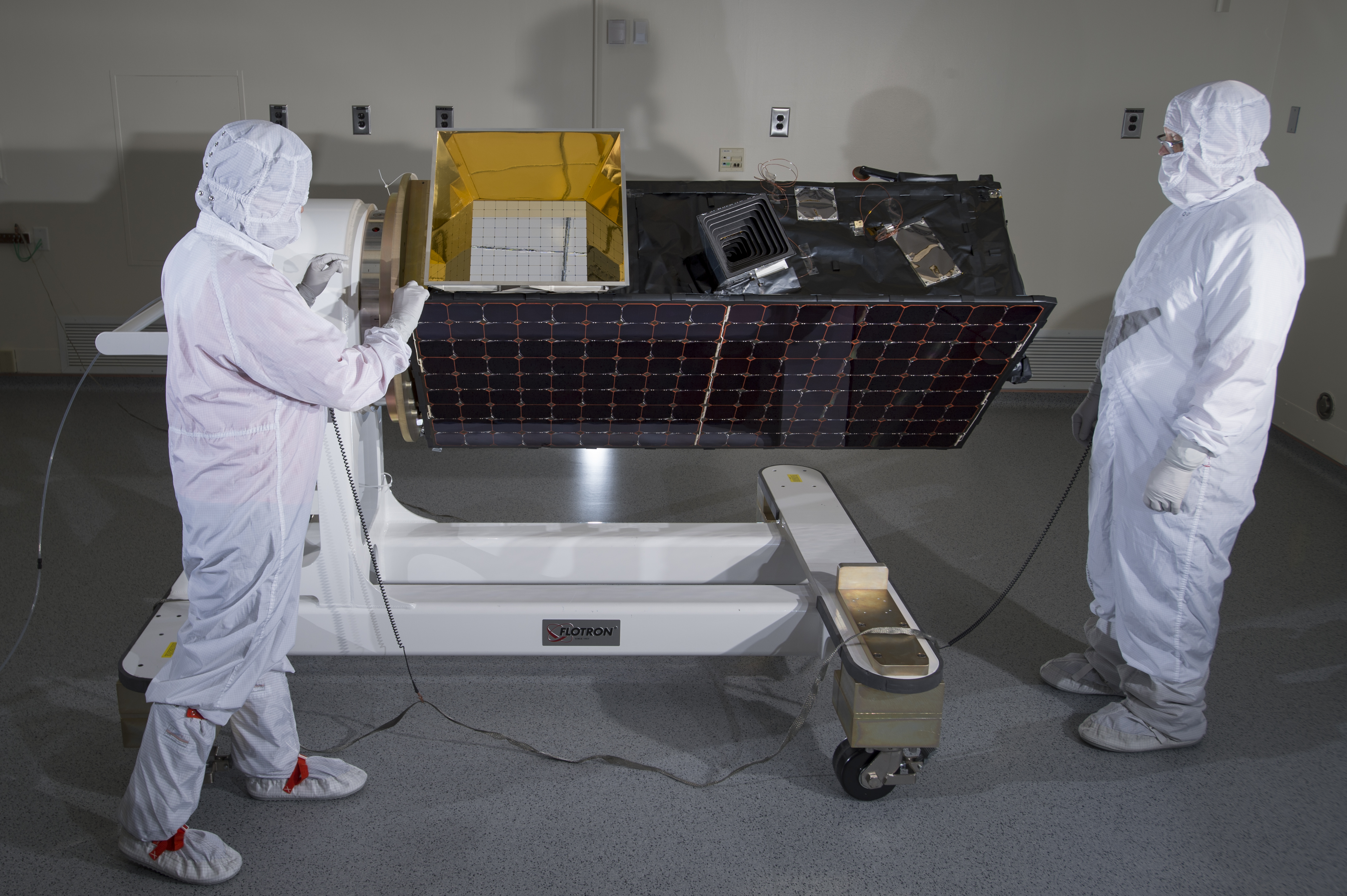 An engineer inspects SensorSat prior to thermal-vacuum testing. Photo: Glen Cooper