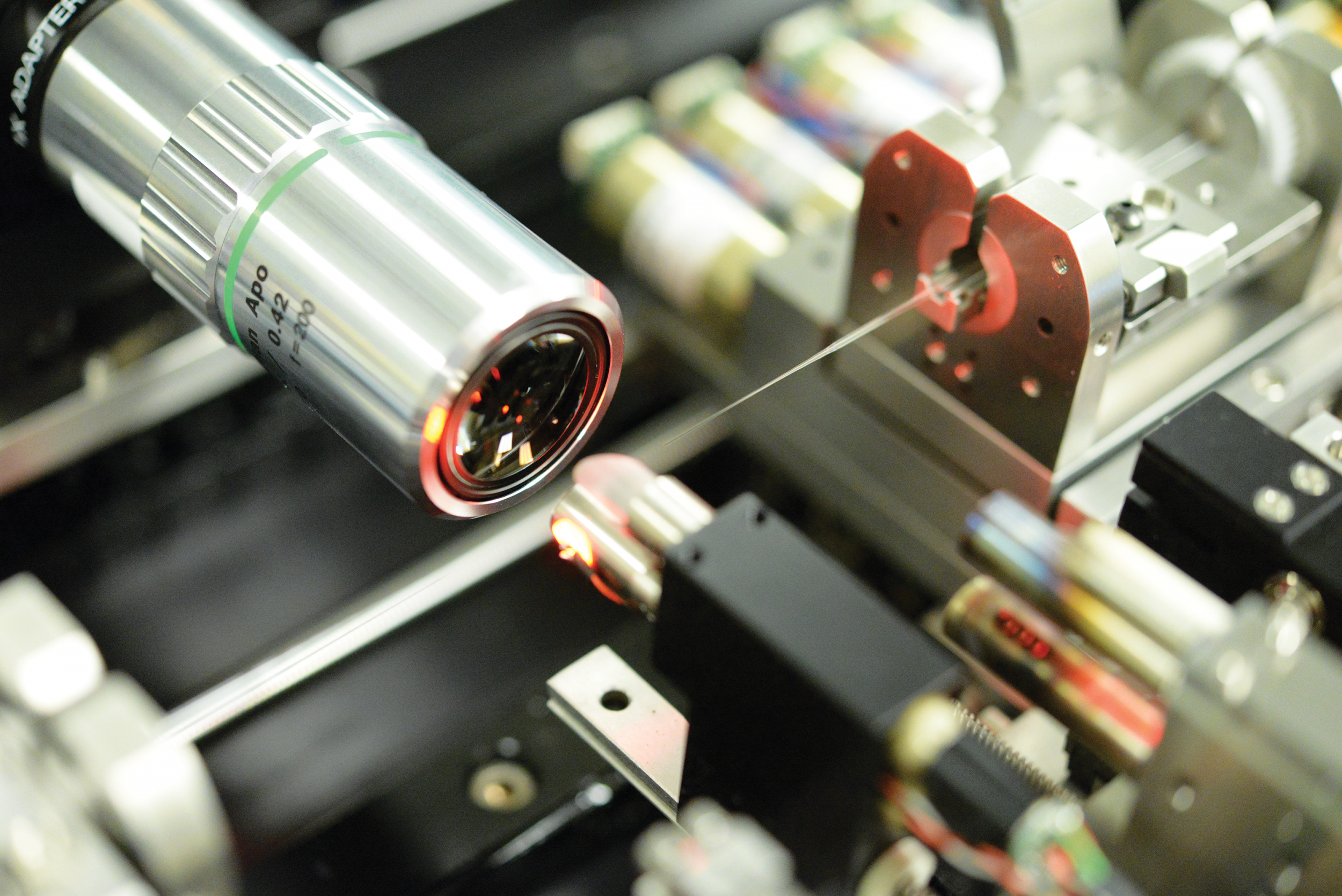 The tip of the photonic lantern is inspected with a microscope prior to being spliced into a kilowatt-class amplifier. 