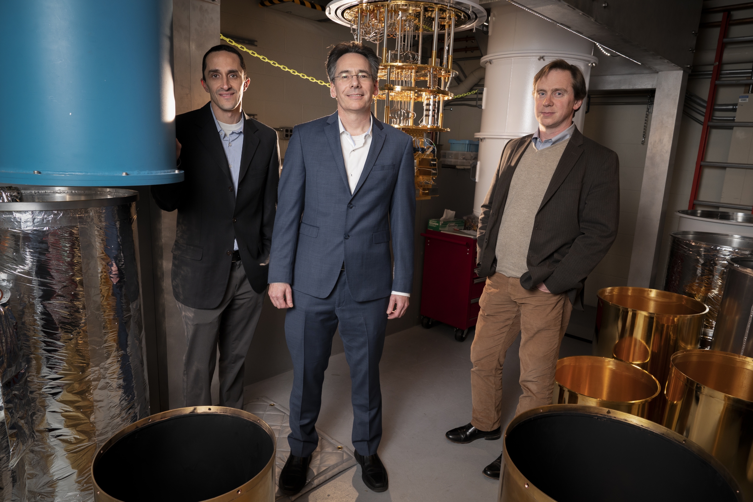 Three researchers in the quantum research laboratory