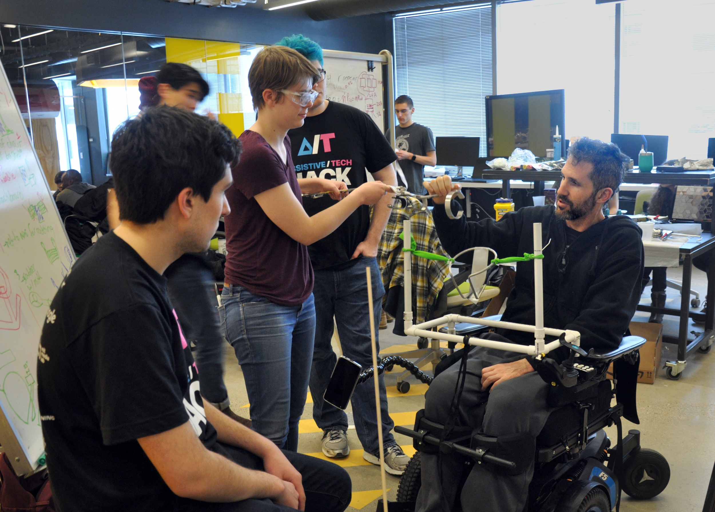 Alex Rosenberg works with his team to create a technology to play catch with his sons. Photo: MIT Assistive Technology Club