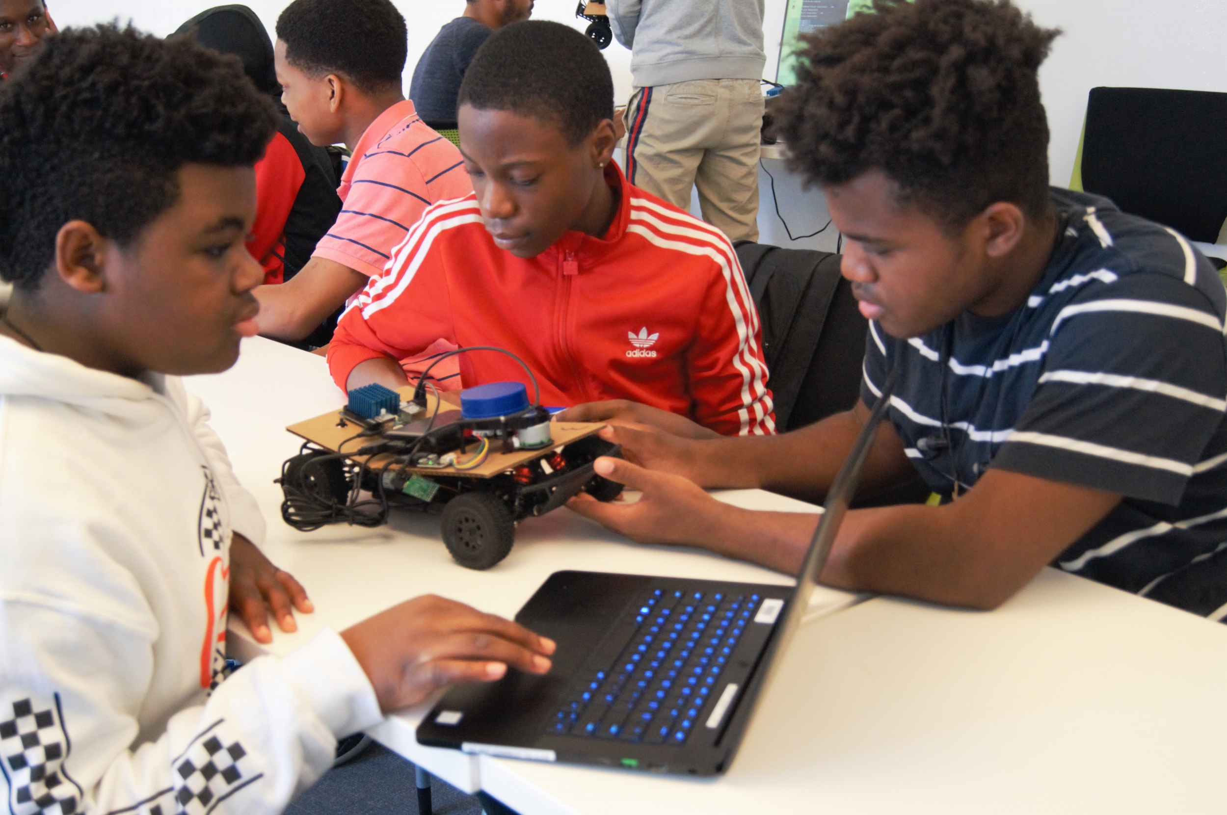 Because there were only four racecars available, students worked in teams to write the code for their cars. Photo: Madelaine Millar