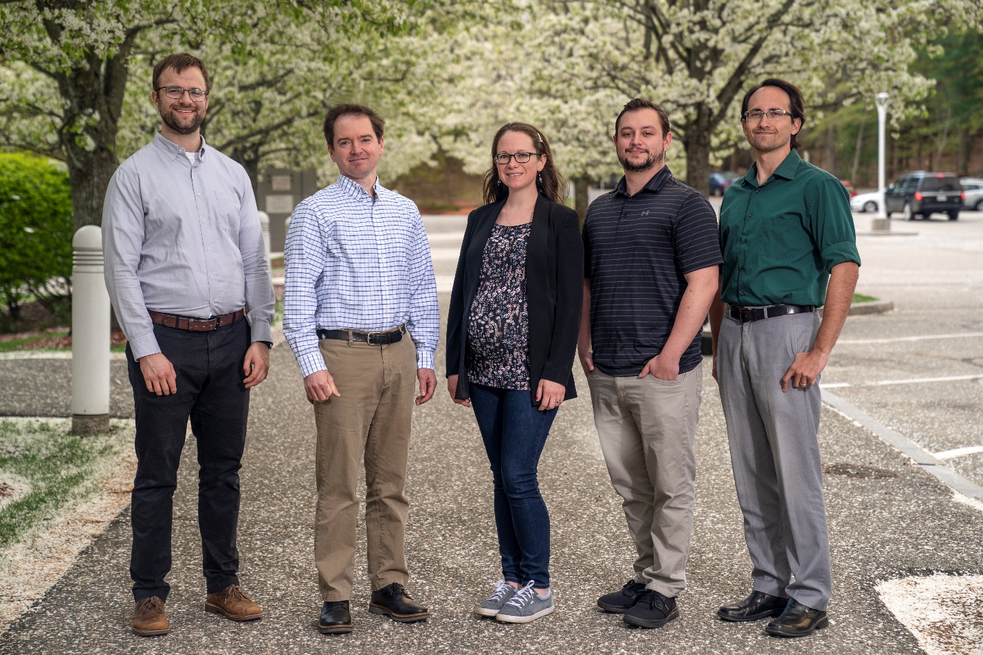 Five staff members pose for a group photo.
