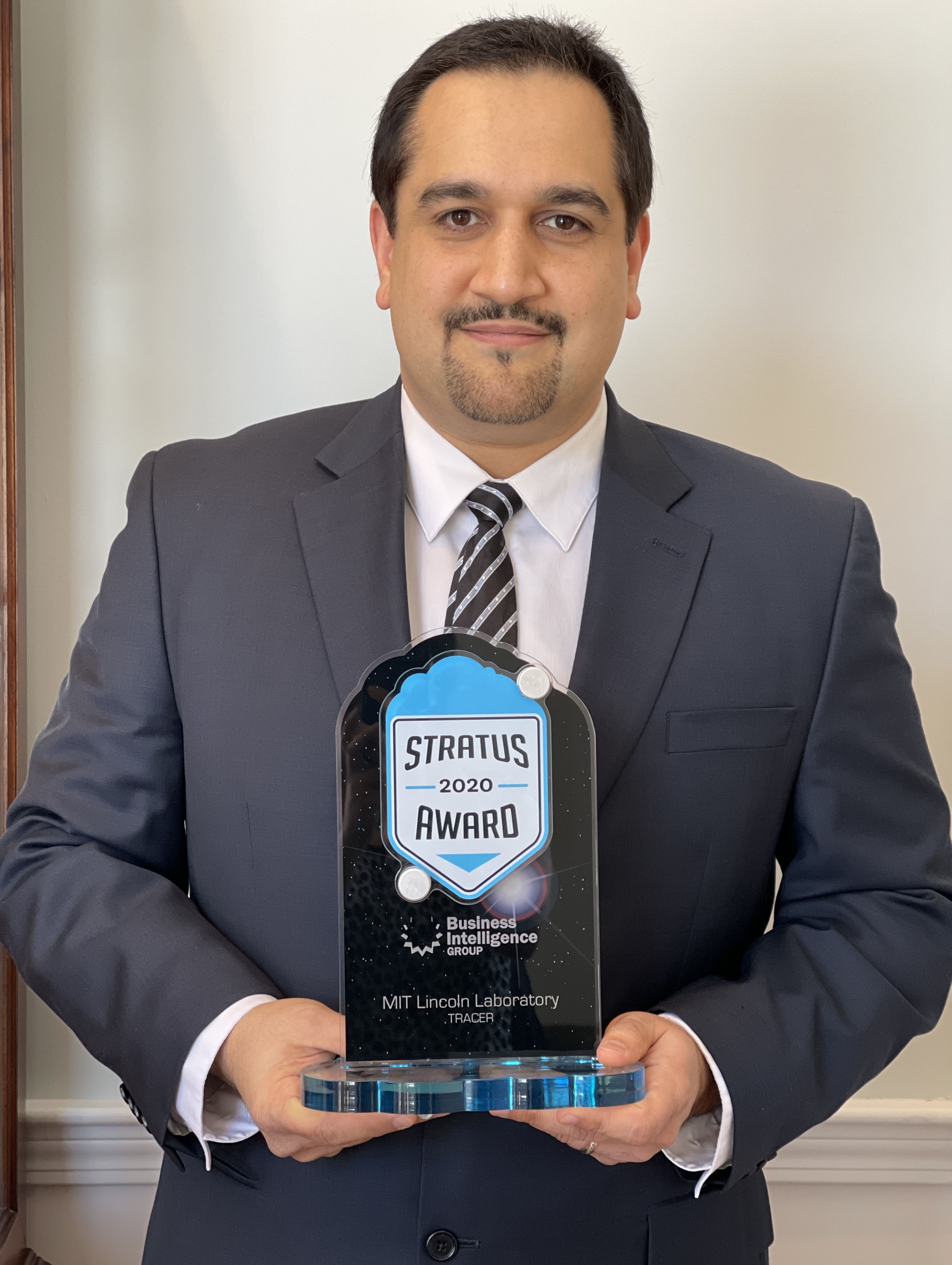 This is a photo of Hamed Okhravi with the Stratus Award trophy.