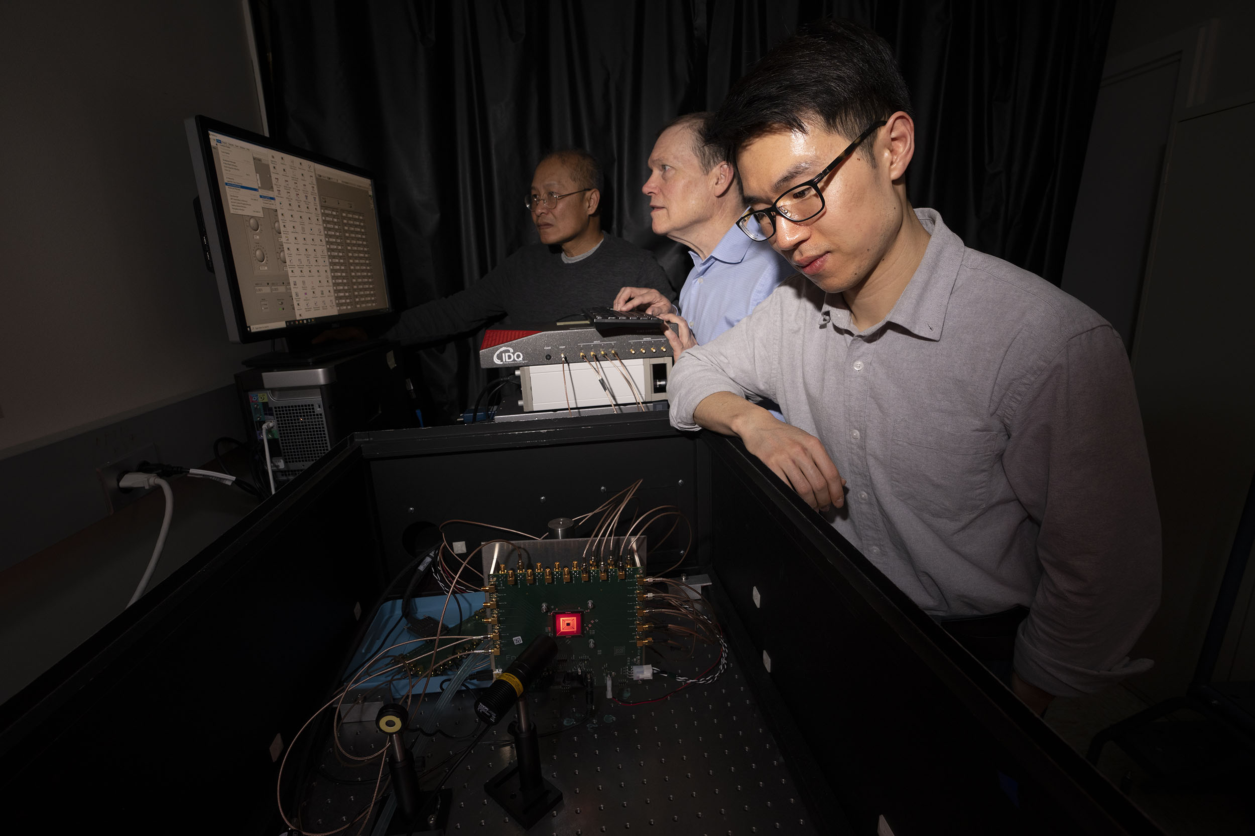 From left to right, Niyom Lue, Jonathan Richardson, and Tom Cheng test the detector in the laboratory.