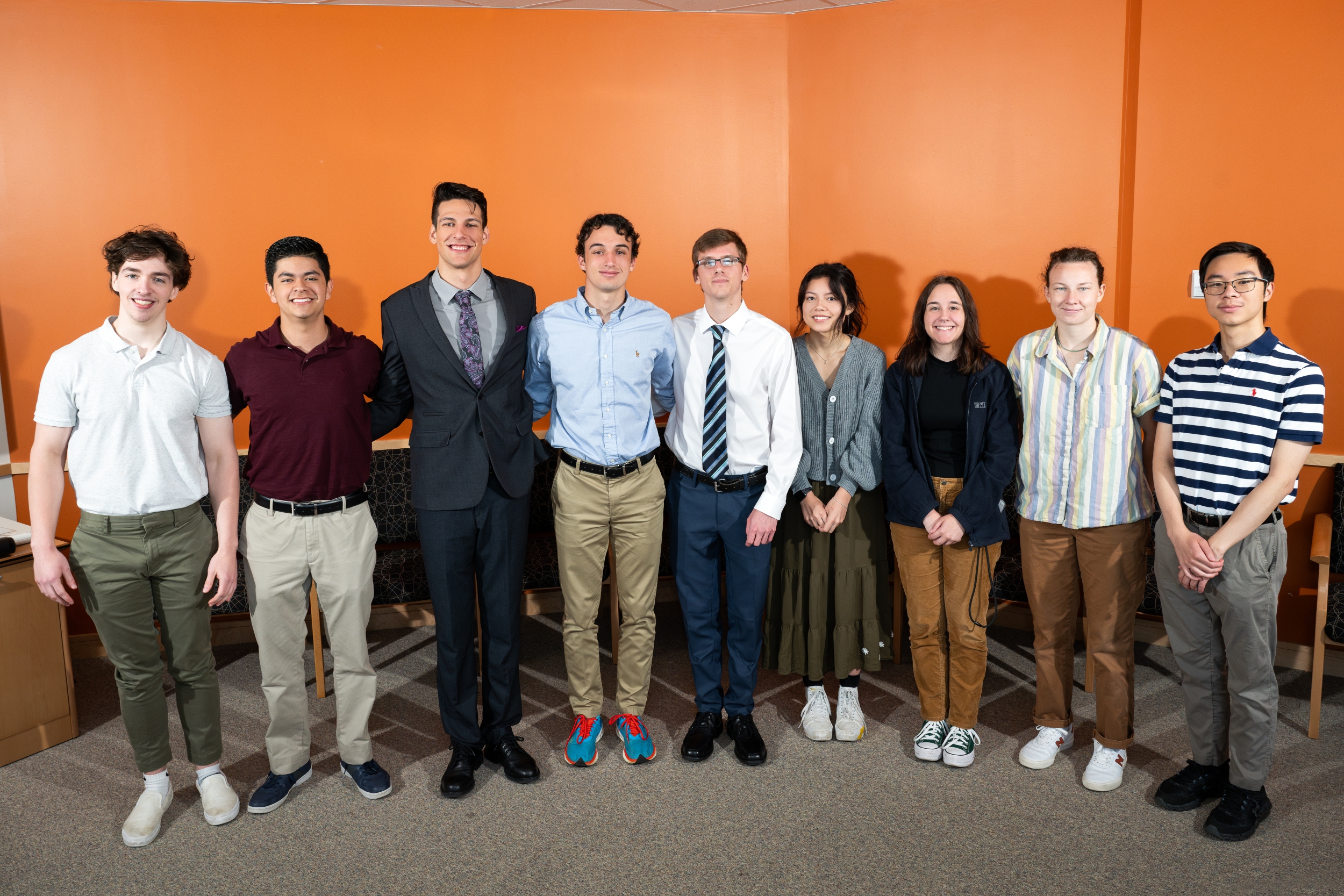 A group of nine interns pose for a group photo