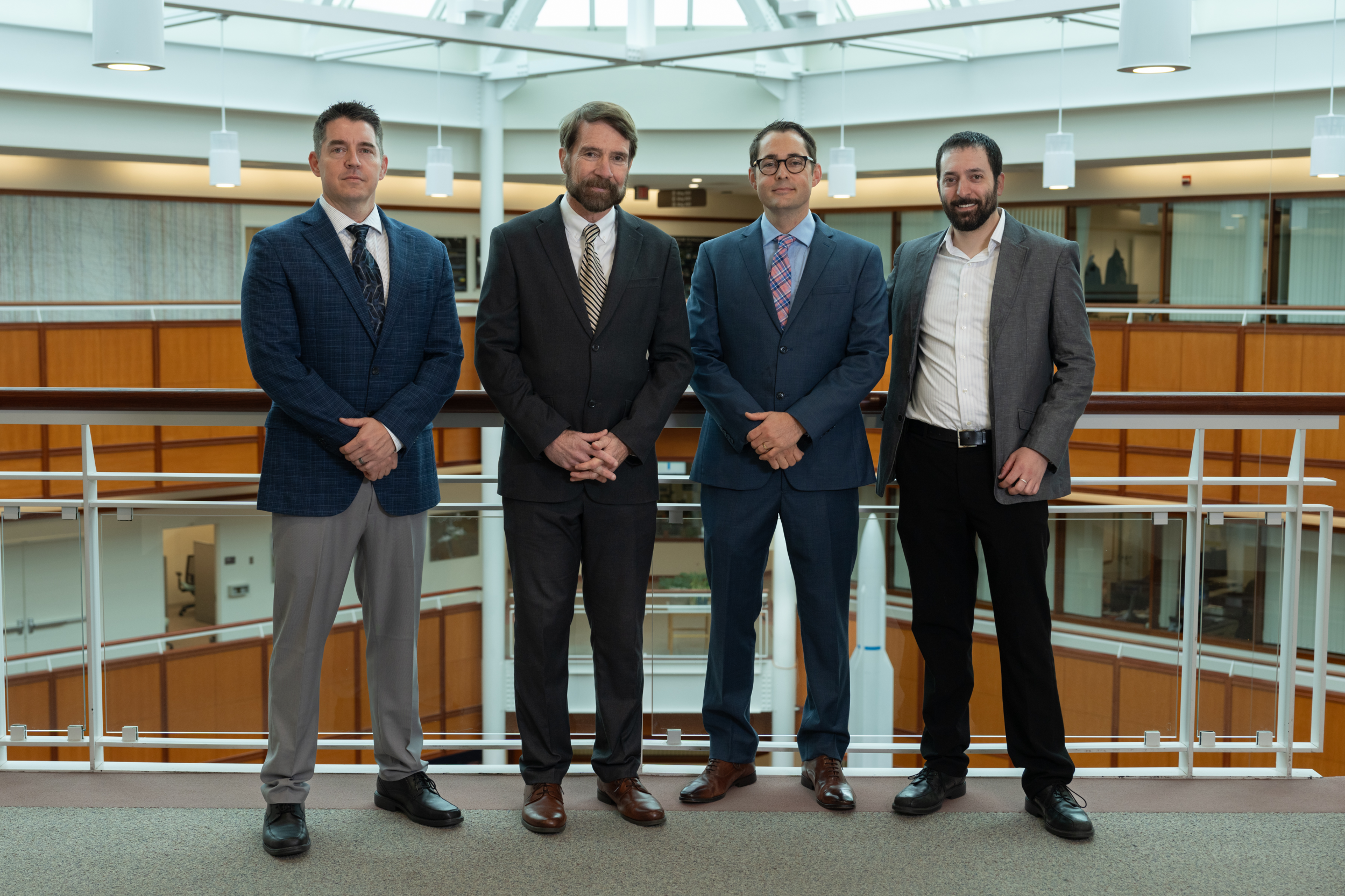 Four leaders representing Air University and Lincoln Laboratory stand for a group photo.