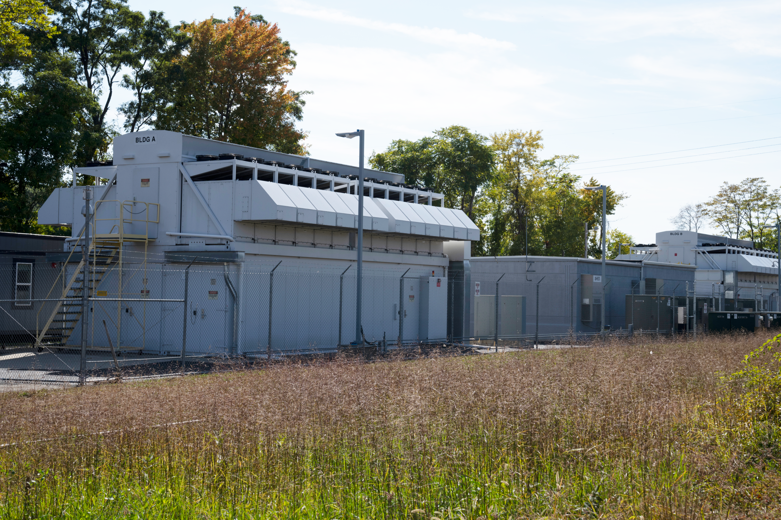 The exterior of a data center next to a meadow.