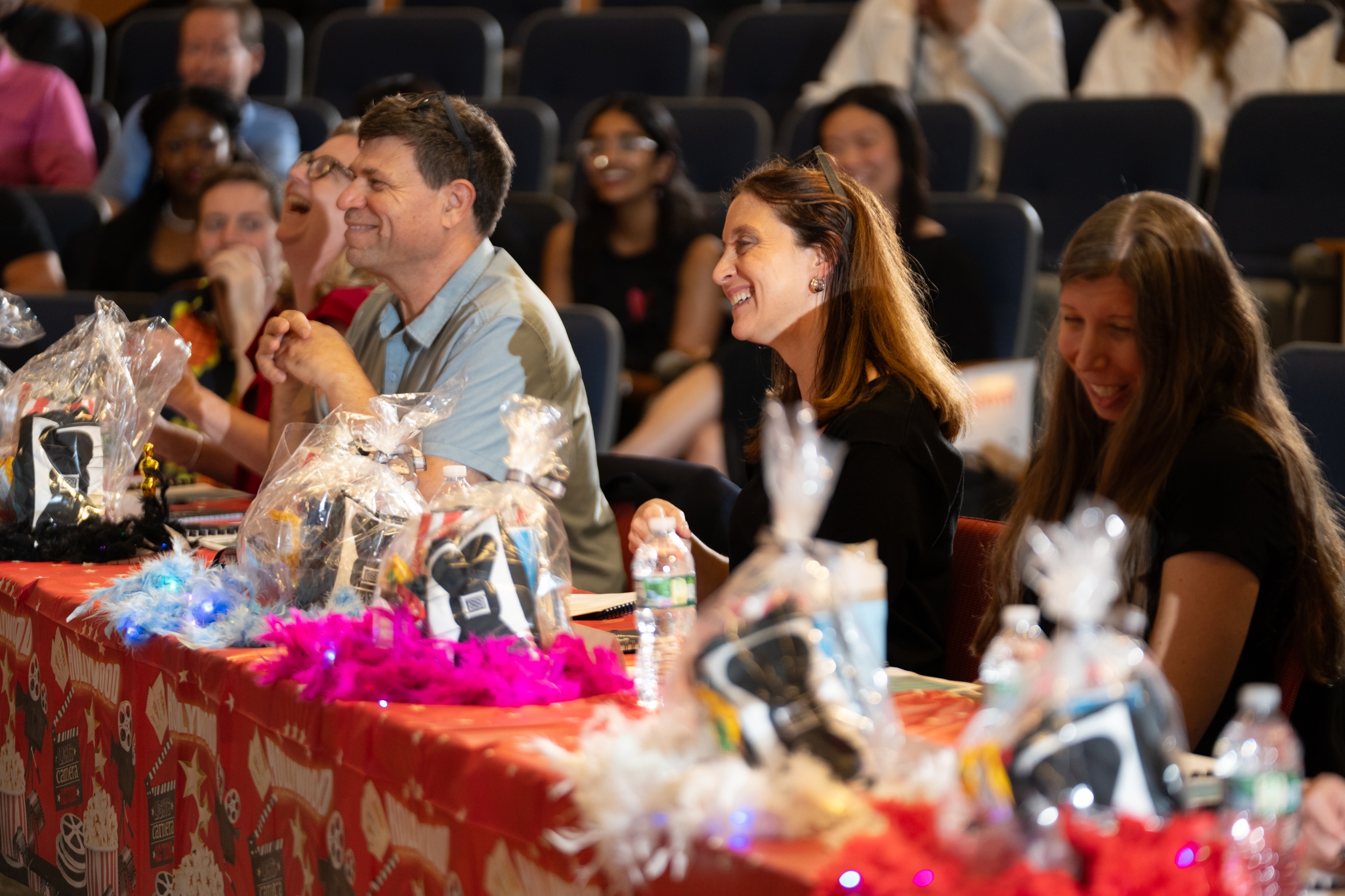 Four judges sit at a decorated table for the event.