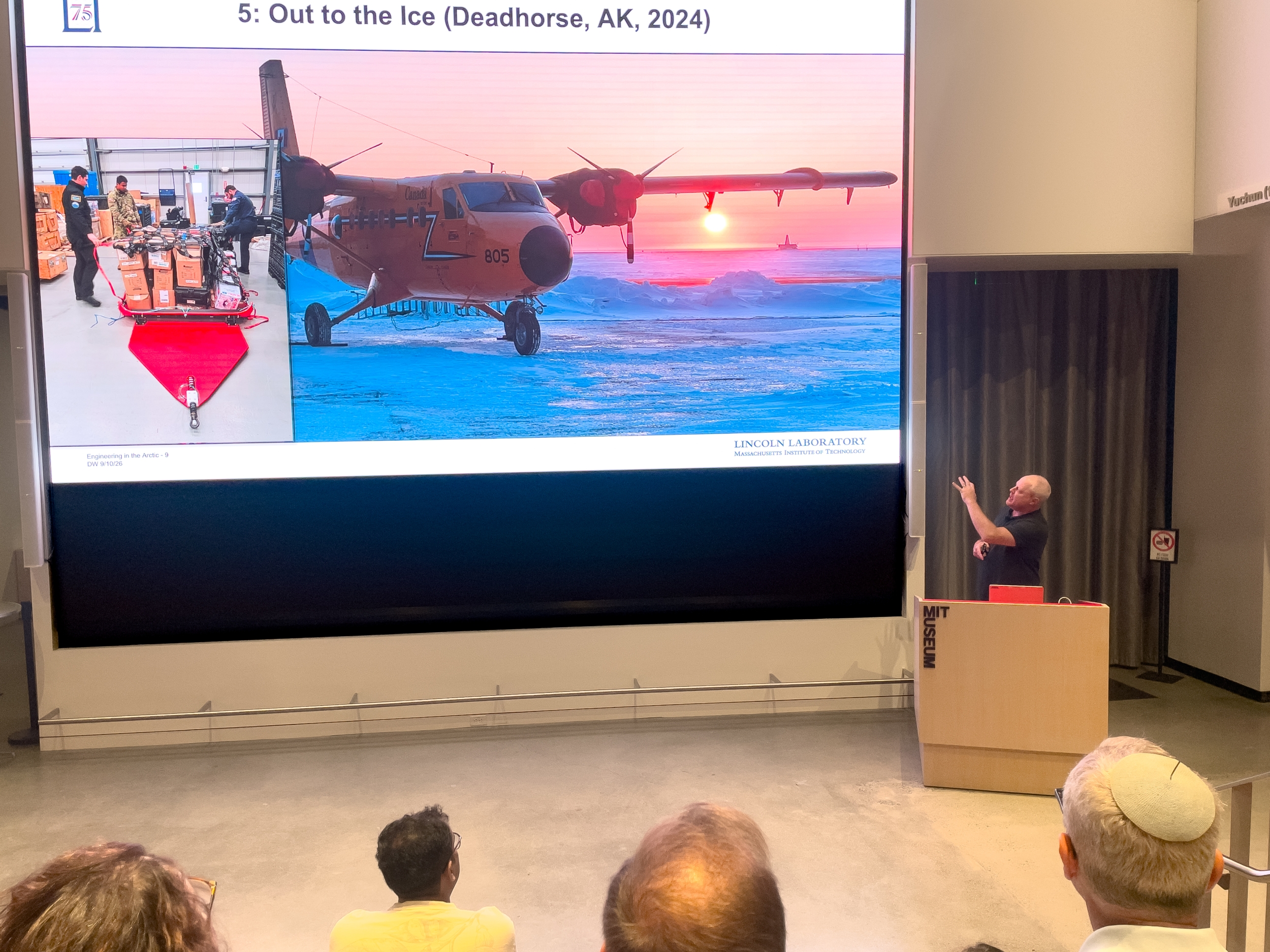 A presenter explains a presentation slide to an audience. 