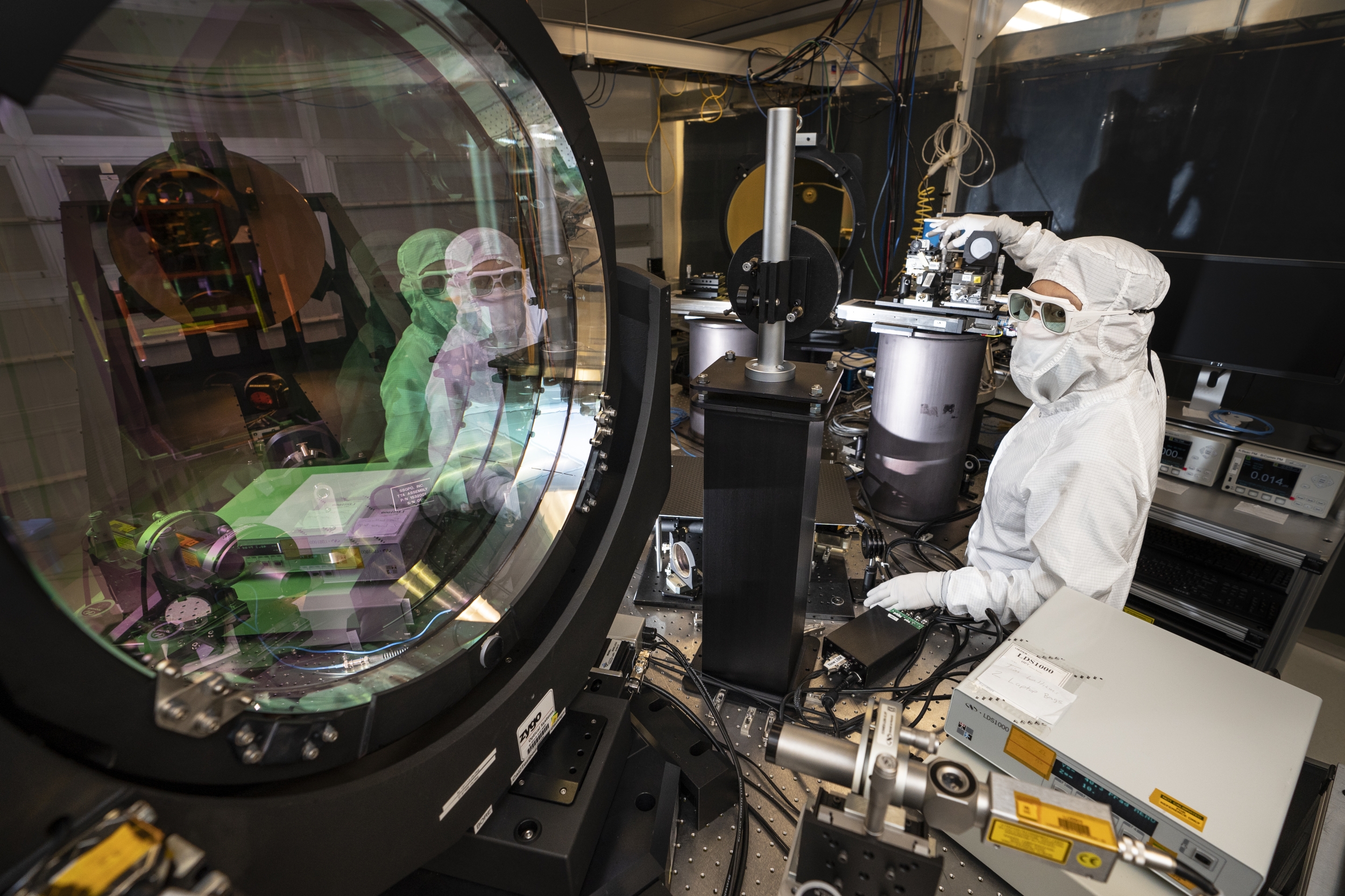 This is a photograph of a researcher conducting tests in the Optical Terminal Verification Testbed.