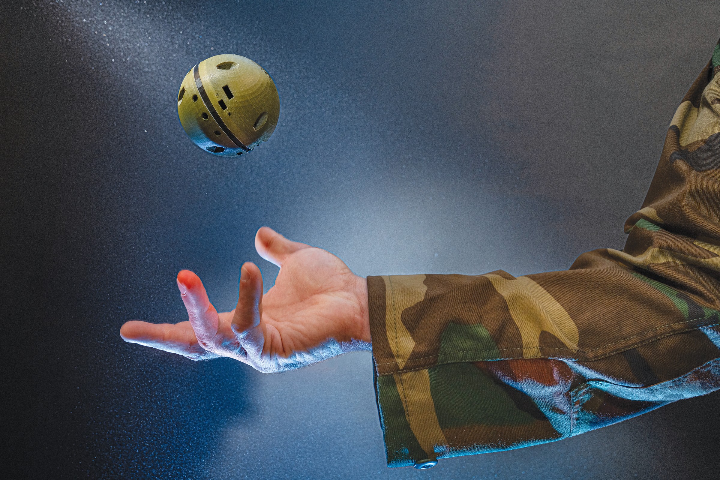 Photograph of the small chemcial sensign beign tosssed by hand