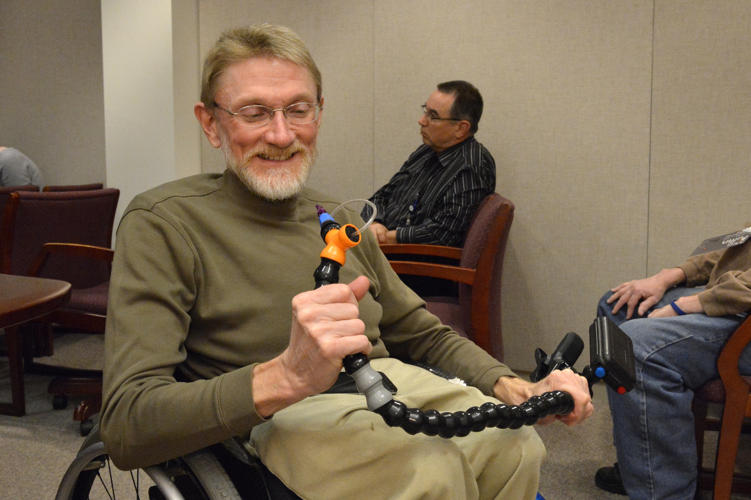 A LED committee member, Gary Brendel, helped organize a seminar for employees to learn more about the Puffin, a wireless sip-and-puff joystick controller designed by MIT students for a client with cerebral palsy.