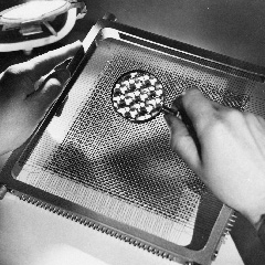 This close-up photograph of a magnetic-core memory array shows the 64 × 64 arrangement of magnetic elements on the surface plane.