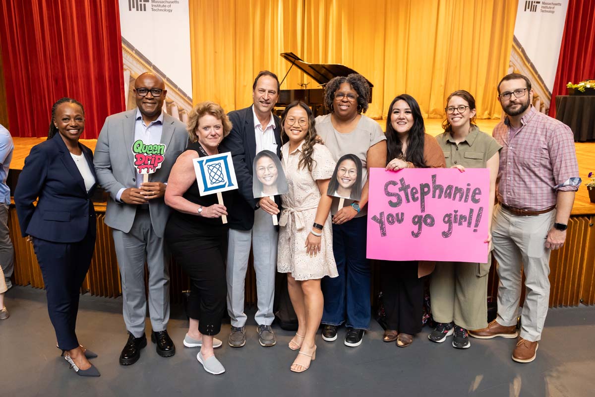 LIncoln Laboratory staff gather for a group photo with signs for Stephanie Tran's MIT Excellence Award.