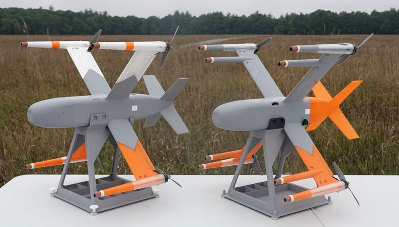 Two SICA prototypes, 3D-printed, X-wing-style interceptors measuring 21 by 22 inches, are photographed on a table in a field.
