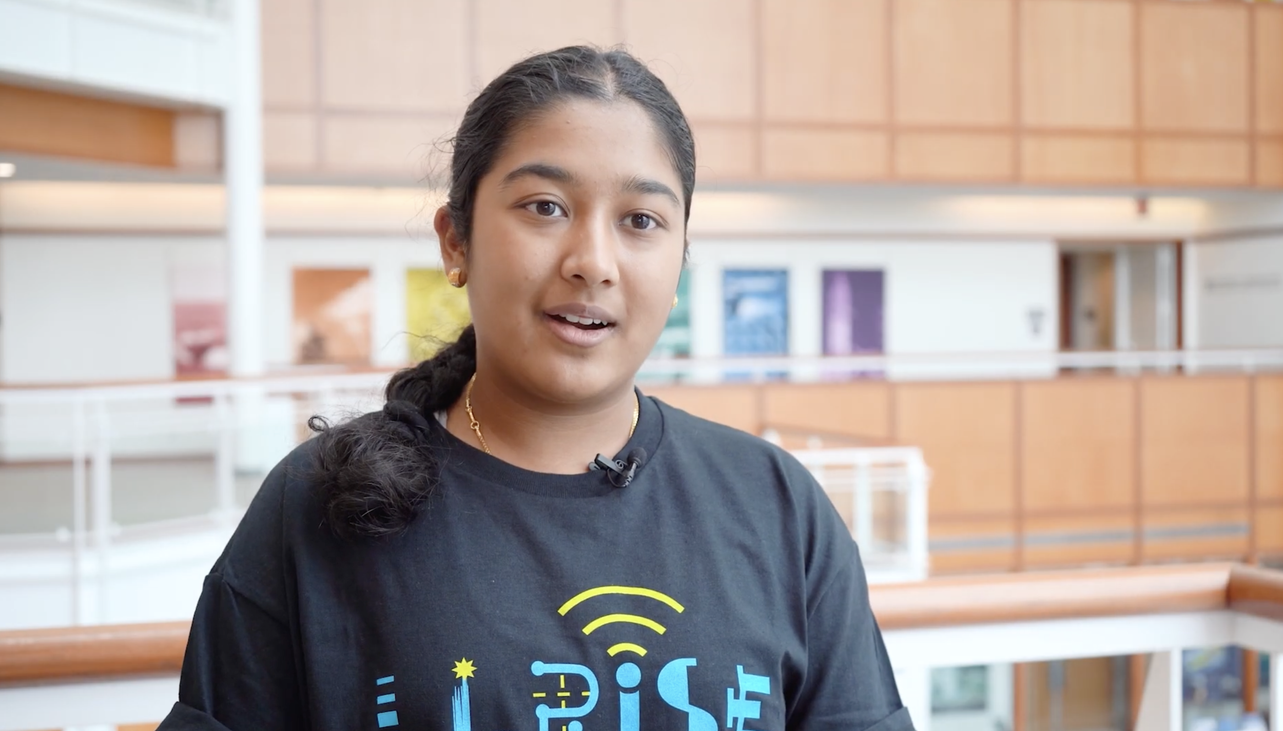 A high school LLRISE student is interviewed in the main lobby of Lincoln Laboratory.