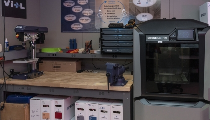 an image inside of the VITL lab showing a mechanical assembly bench and a large 3D printer.