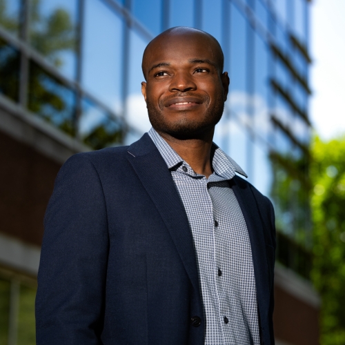 An outdoor portrait photograph of Peter Asuzu. 