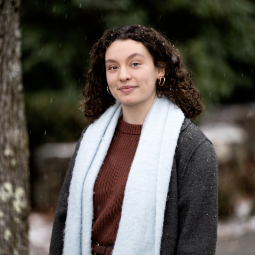 A photo of Madeline McLaughlin outside, with snow lightly falling. 