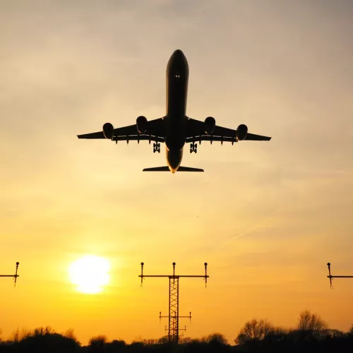A photo of a plane taking off a runway 