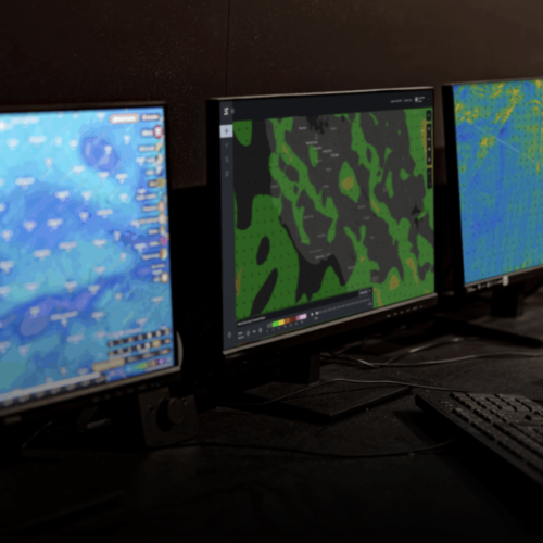 Four monitors displaying weather and air radar returns