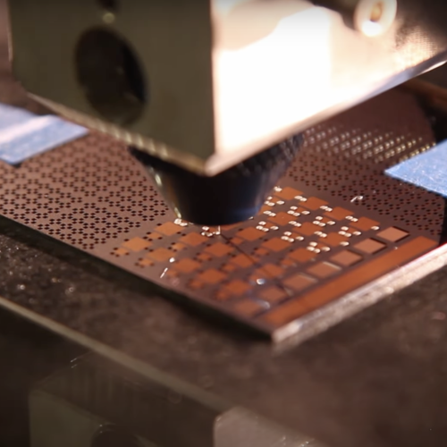 a close-up view of a 3D printer head depositing material.