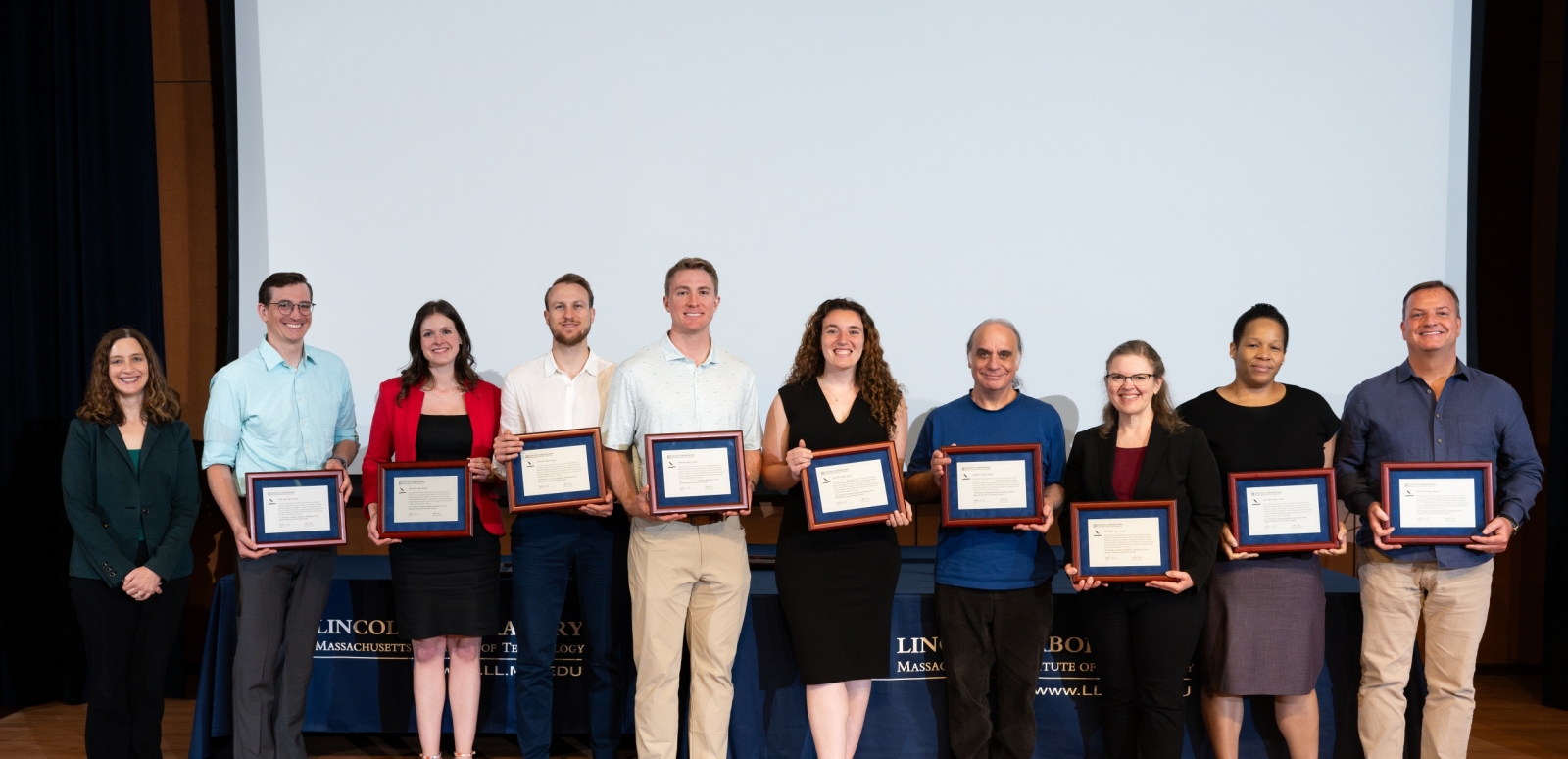 Group photo of the 2024 best paper award recipients in the Auditorium with Melissa Choi
