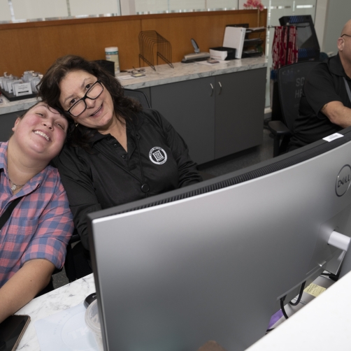 SSD employees sit behind computer monitors