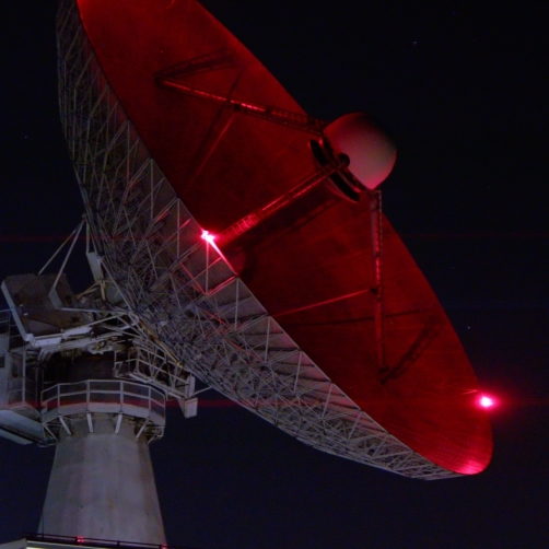 a large radar dish at night