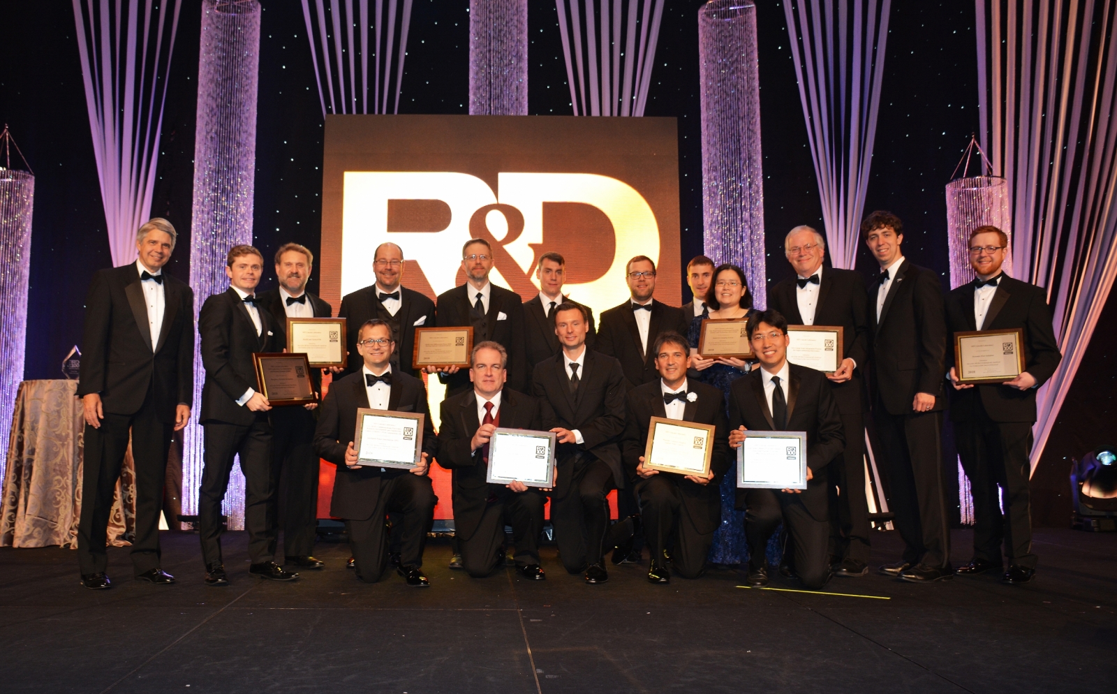 The principal researchers of MIT Lincoln Laboratory's 12 finalists for 2018 R&D 100 Awards are pictured here with Lincoln Laboratory Director Eric Evans (far left). The principal researchers of the 10 winning technologies hold up their award plaques. 