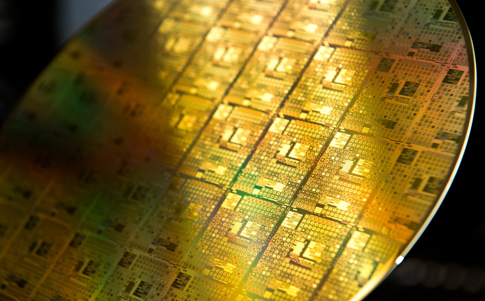 A photo of gold-colored integrated circuit wafer.