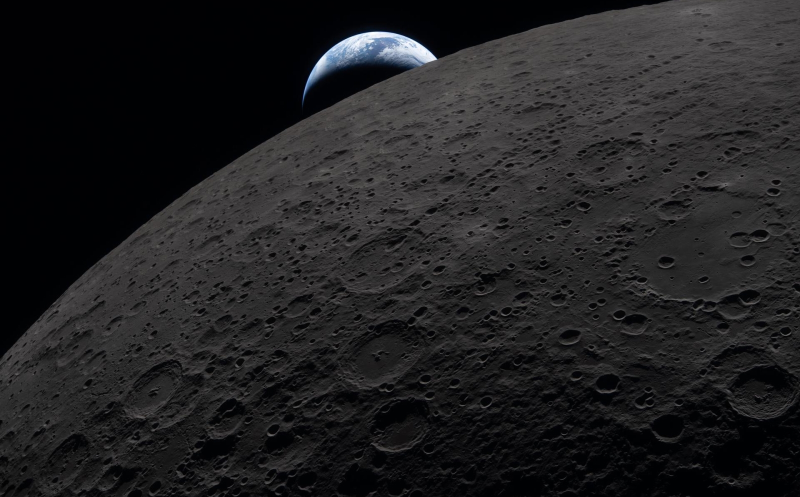 Earth sets behind the Moon on April 6, 2026, as captured from the Artemis II Orion spacecraft.