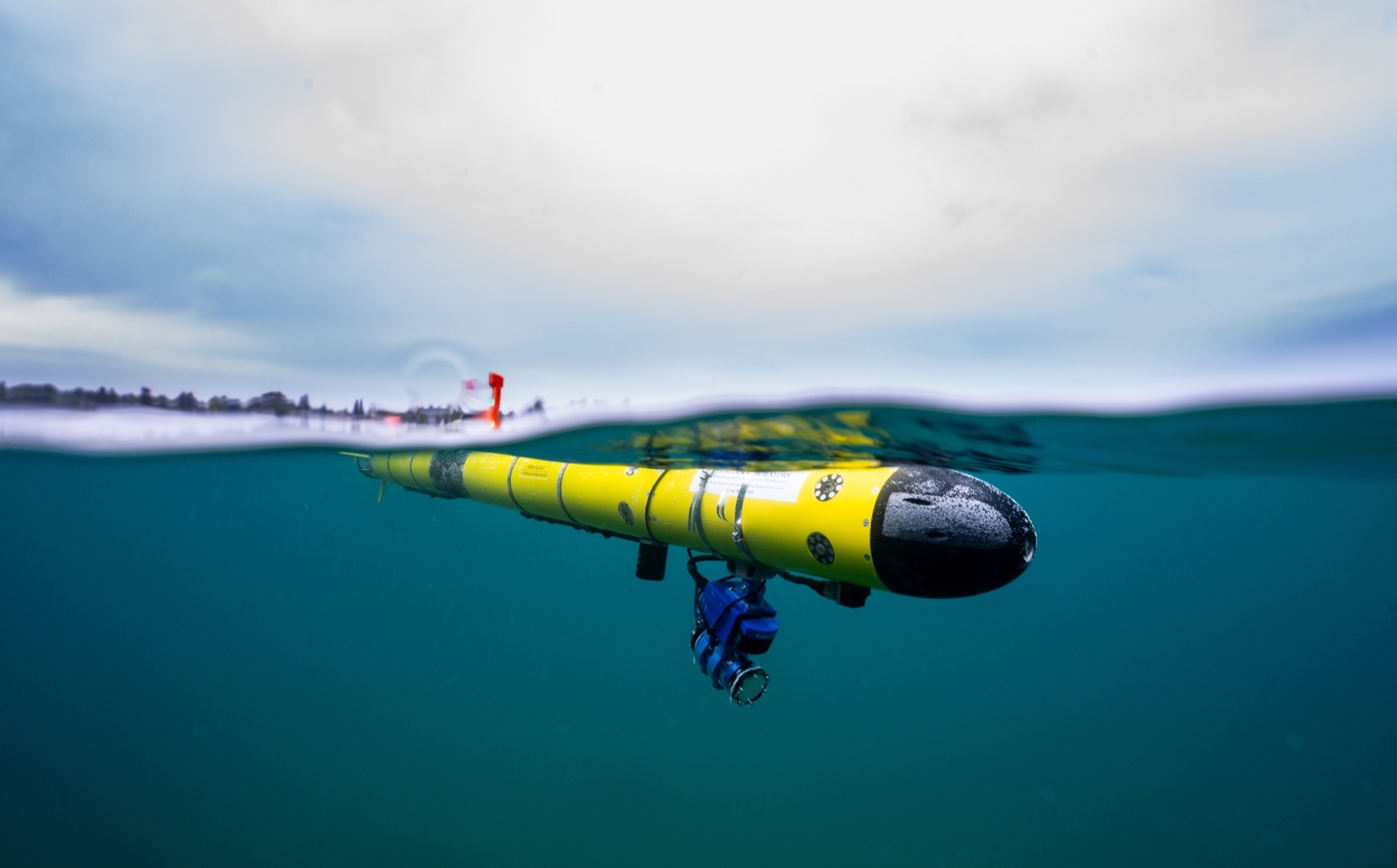 A photo of an underwater robot just under the water's surface. 