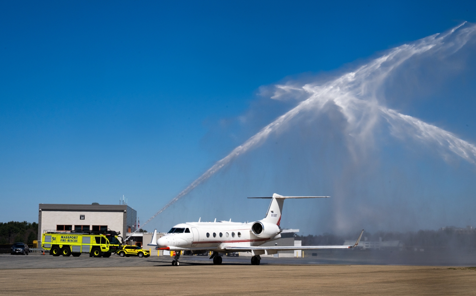 Water shoots over an aircraft.