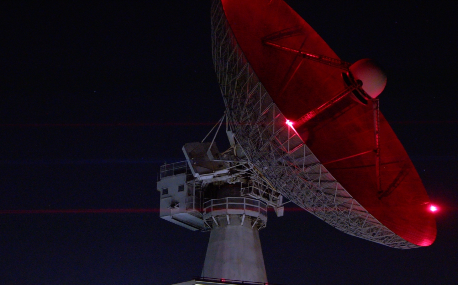 a radar dish at night