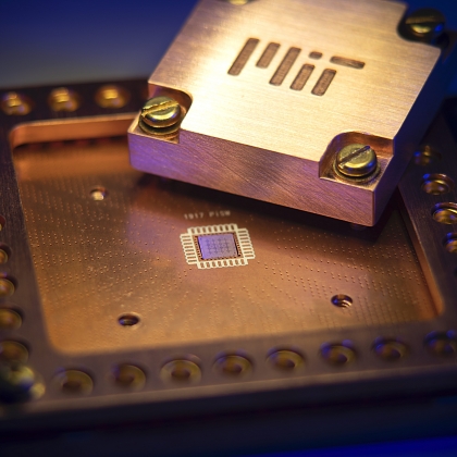 A photo of a quantum chip with MIT etched into metal. 