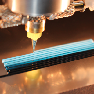 Lincoln Laboratory's custom active mixing nozzle is used in direct ink writing with tailored nanocomposite materials.