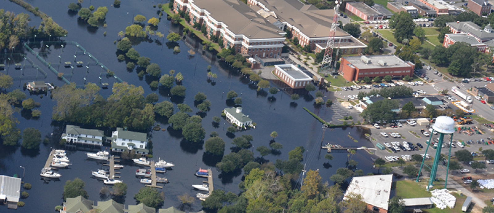 aerial image showing a neighborhood flooded by a natural disaster. 