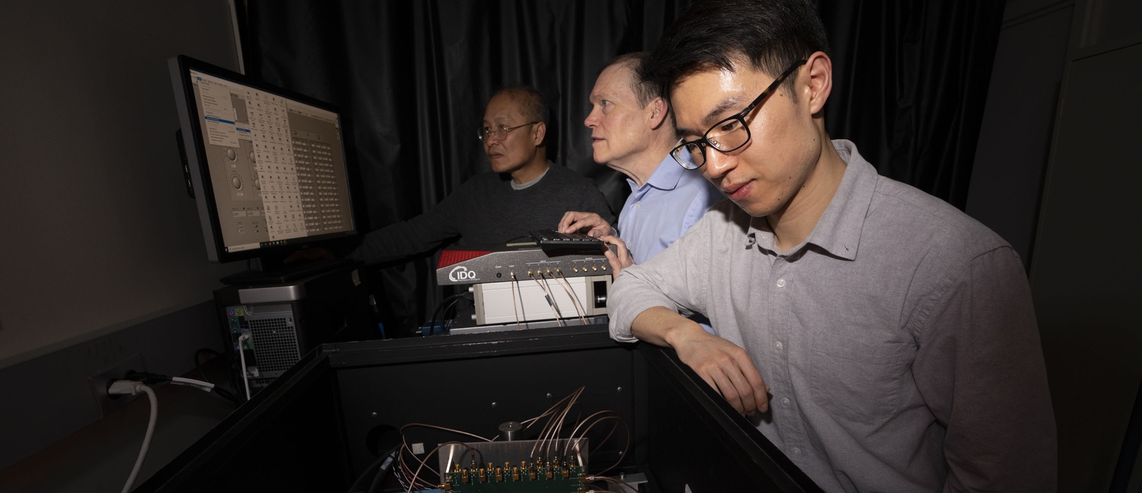 From left to right, Niyom Lue, Jonathan Richardson, and Tom Cheng test the detector in the laboratory.