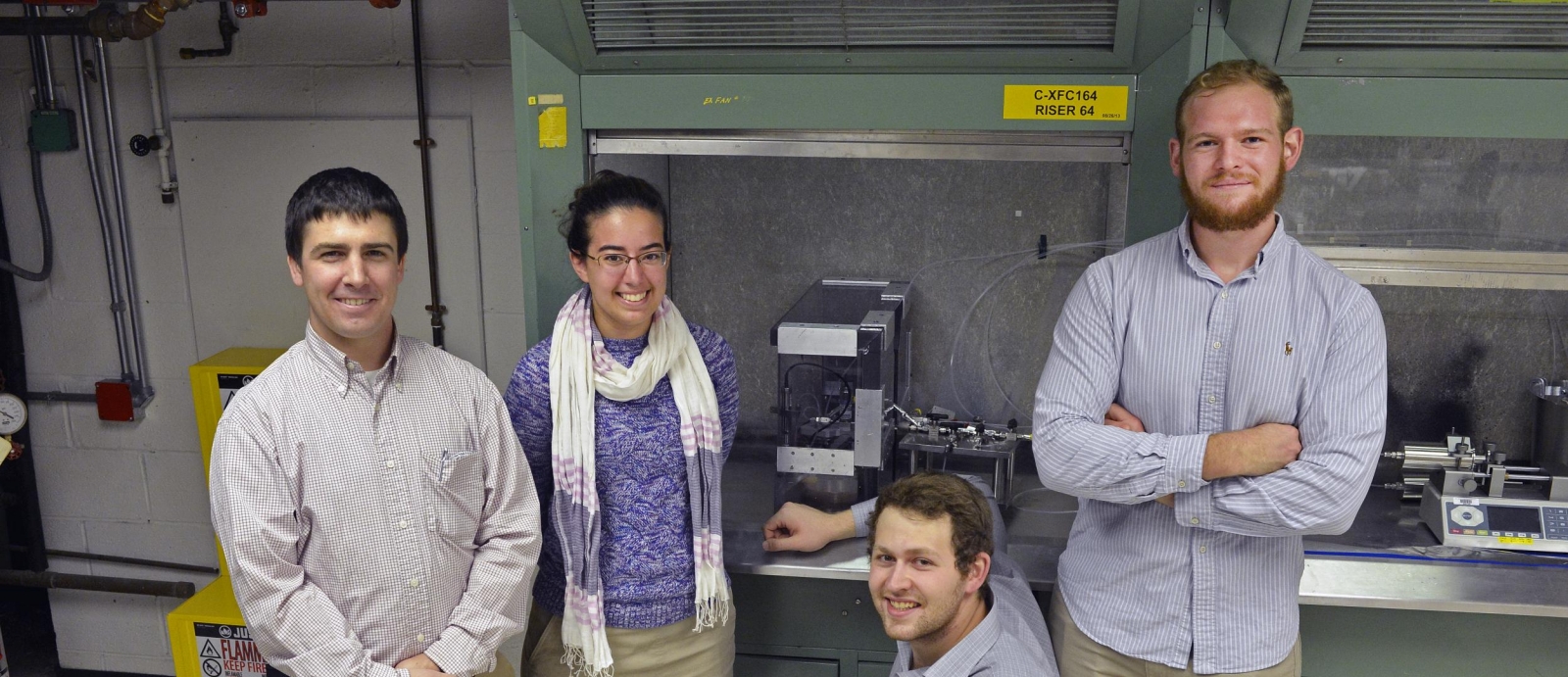 WPI students, with the guidance of their Lincoln Laboratory mentor (left) developed a liquid-propellant propulsion system for picosatellites for their Major Qualifying Project.