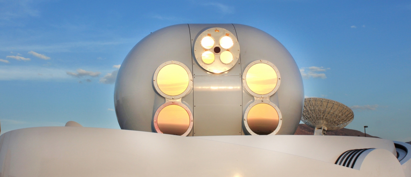 The protective windows on the telescopes of the Lunar Laser Communication Demonstration's ground terminal on White Sands Missile Range, New Mexico, reflect the desert sunset.