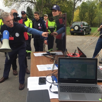 Gregory Hogan, pointing to a monitor, shows VIP visitors (including country ministers, dignitaries, and the U.S. Ambassador to Bosnia & Herzegovina) the capabilities available in NICS for responders during the rescue operations. Photo courtesy of DHS S&T