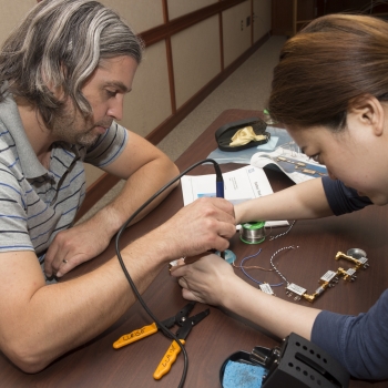 Brunner, left, assembles a radar component with help from one of the LLRISE instructors.